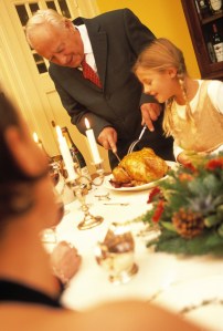 Man Carving Turkey at Christmas Dinner